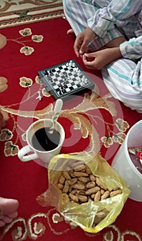 Playing chess with a cup of coffee and rosted peanut