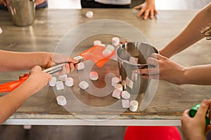 Playing with children: hands on the table with marshmallows, bucket, shovel. Animator for children.