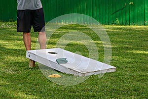 Playing cornhole game on a sunny day in the backyard