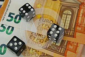 Playing dice and Euro banknotes. Gambling and finance.