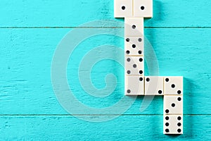 Playing dominoes on a blue wooden table