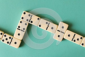 Playing dominoes on a light background . The concept of the game