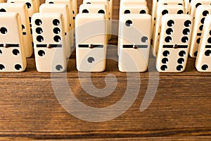 Playing dominoes on a wooden table. Close up. Dominoes game concept