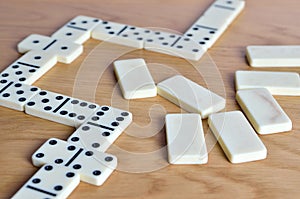 Playing dominoes on a wooden table. Dominoes game concept