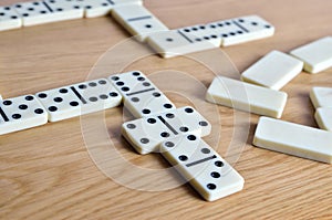 Playing dominoes on a wooden table. Dominoes game concept