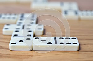 Playing dominoes on a wooden table. Dominoes game concept