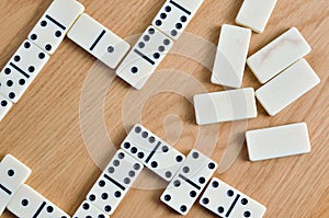 Playing dominoes on a wooden table. Dominoes game concept
