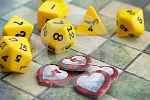 Playing Dungeons and Dragons. Dices, tiled map, indicators of health in the form of heartsr