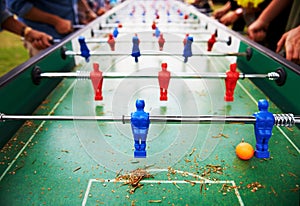 Playing, foosball and people outdoor with table, game or closeup on competition with ping pong ball. Soccer, board and