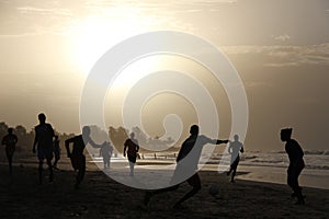 Playing football on the gambian beach