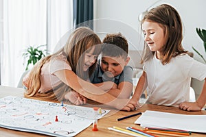 Playing game together. Kids having fun in the domestic room at daytime