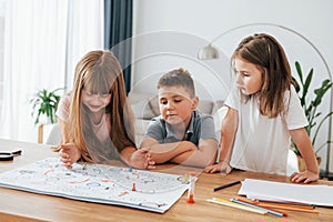 Playing game together. Kids having fun in the domestic room at daytime