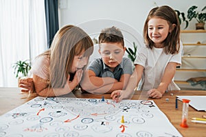 Playing game together. Kids having fun in the domestic room at daytime