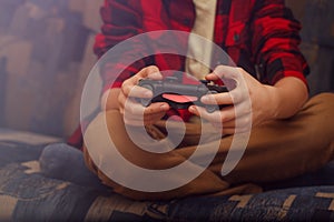 Playing games concept. Boy hands holding gamepad