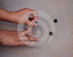 Playing with Glass Marbles an old nostalgic village game