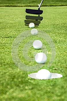 Playing Golf - Putting a ball into the hole