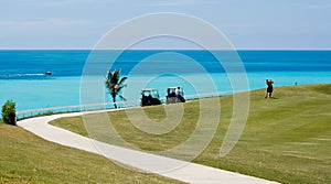 Playing golf on a tropical golf course, over looking the ocean