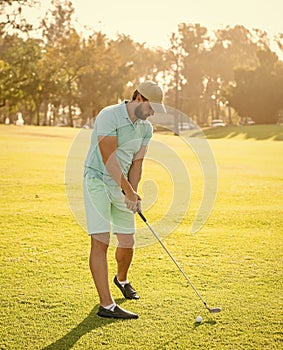 playing golfer in cap with golf club, recreation