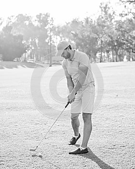 playing golfer in cap with golf club, recreation