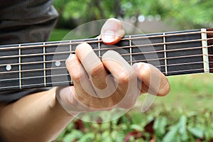 Playing guitar chord F#