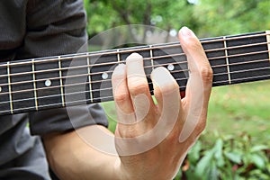 Playing guitar chord F#