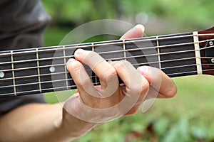 Playing guitar chord F#