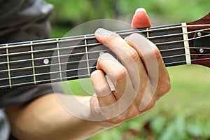 Playing guitar chord G