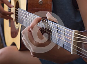 Playing on the guitar, closup.