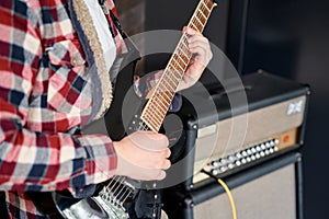 Playing guitar and concert concept. Repetition of rock music band. Man of electric guitar player. Rehearsal base