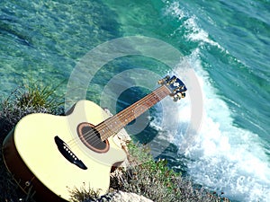 Playing guitar looking the sea