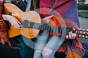 Playing guitar and meeting on roof, close up