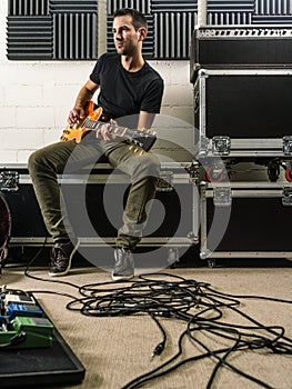 Playing guitar in the rehearsal studio