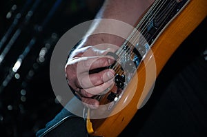 Playing the guitar on a rock concert. Macro 2