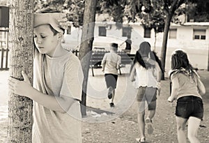 Playing hide and seek. boy closed eyes his hands photo