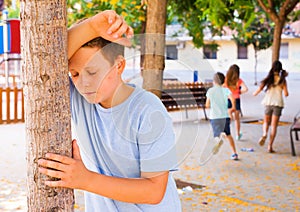 Playing hide and seek. boy closed eyes his hands photo