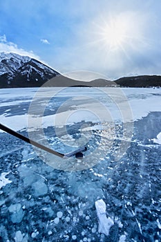Playing Ice Hockey on Frozen Lake Minnewanka in Banff, Alberta, Canada