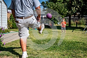 Playing kickball with grandpa in the backyard