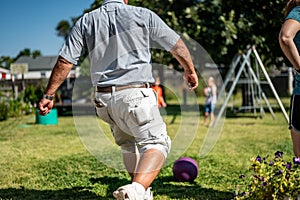 Playing kickball with grandpa in the backyard