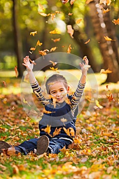 Playing with leaves in autumn