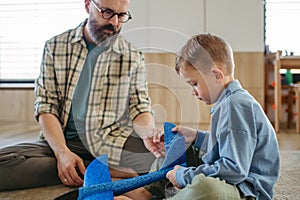 Playing with lightweight styrofoam planes. Playful father and son throwing and flying foam glider planes. Fathers day