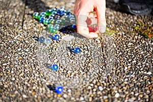 Playing marbles, old children`s game, colorful balls
