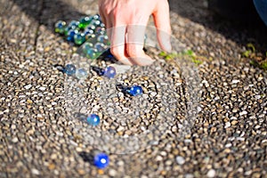 Playing marbles, old children`s game, colorful balls