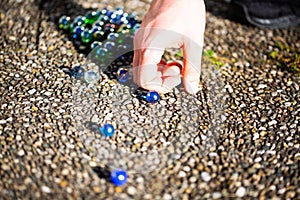 Playing marbles, old children`s game, colorful balls