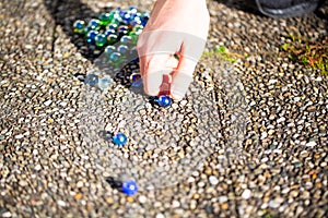 Playing marbles, old children`s game, colorful balls