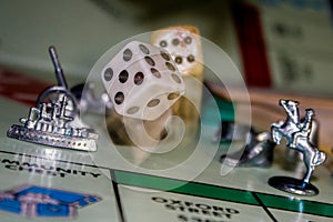 playing Monopoly game board with dice in motion