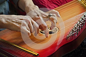 Playing music on lap harp in closeup view