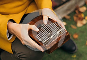 playing the musical instrument Kalimba or Mbira in the fall on the terrace