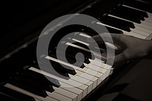 Playing Piano in the studio with black and white tone