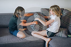 Playing with pillows. Two happy children at home. Family concept