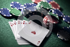Playing poker in a casino holding winning royal flush hand of cards